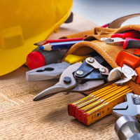 A close up of a tool belt and a hard hat