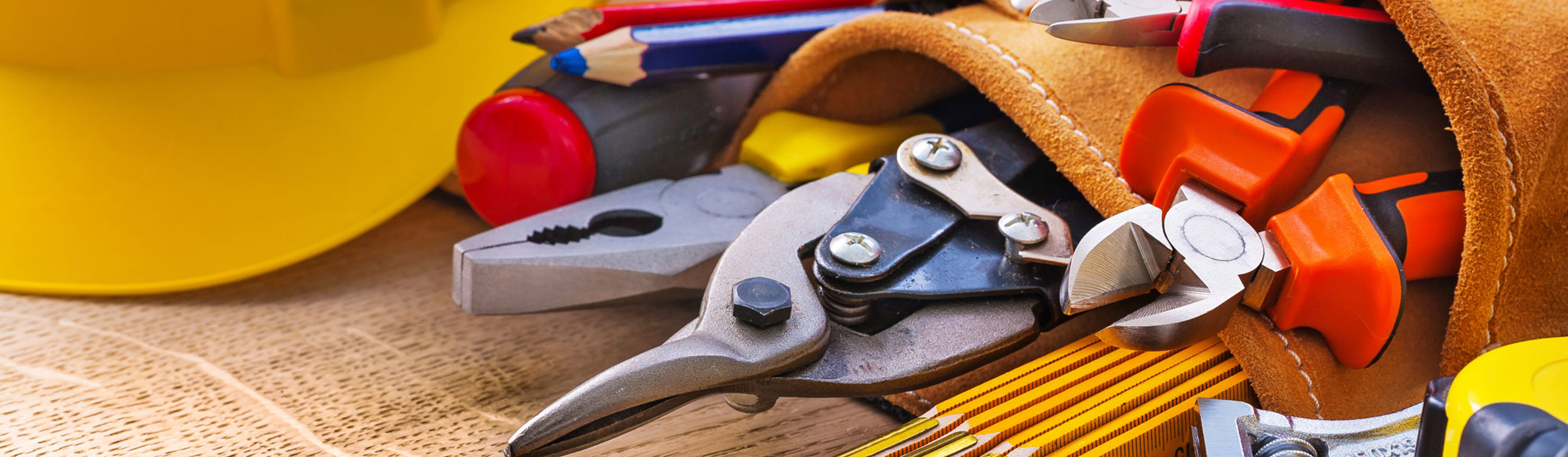 A close up of a tool belt and a hard hat