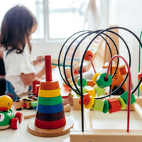 A child playing with a selection of children's toys