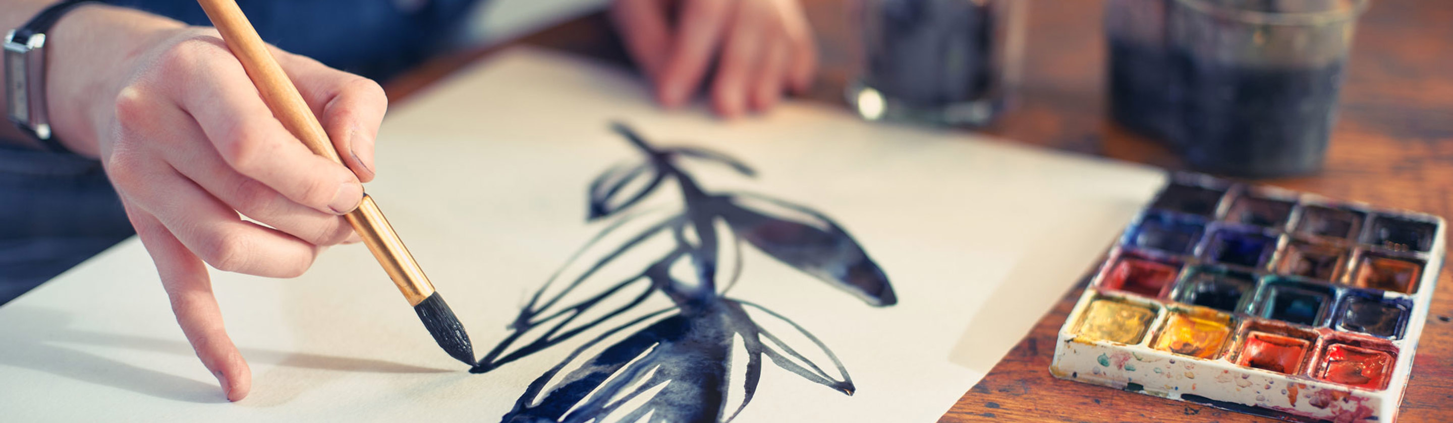 A leafy branch being painted on a blank canvas