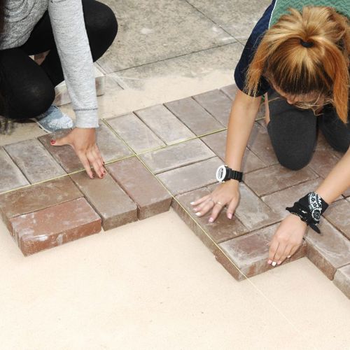 People laying bricks 