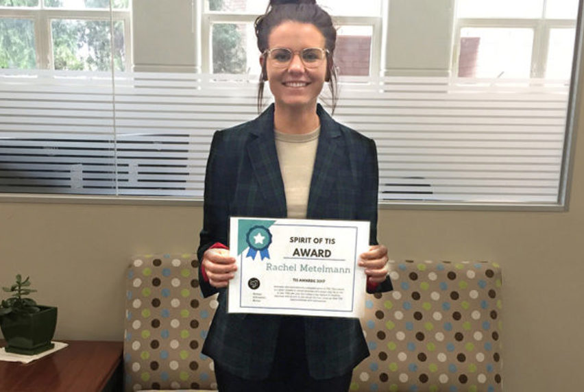 Rachel holding Spirit of TIS Award