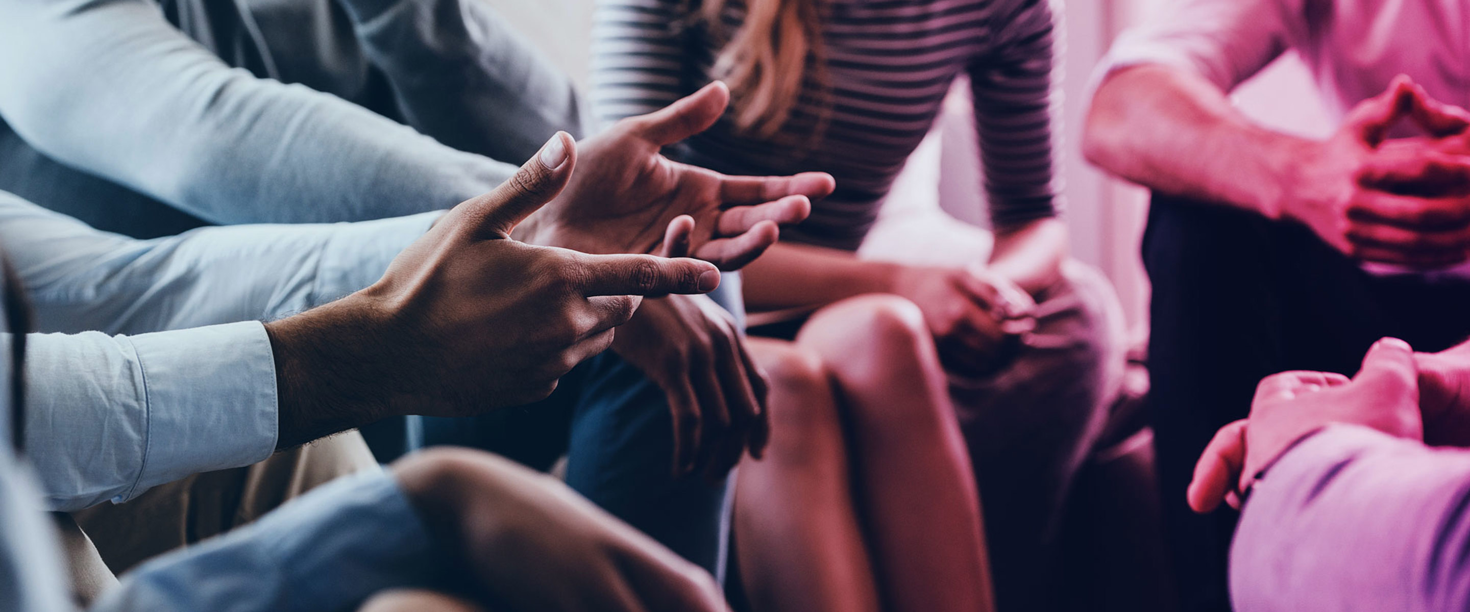 A group of people sitting in a circle and listening to one another talk