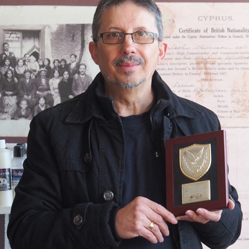 portrait of Con Emmanuelle holding award