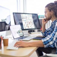 Man sitting at computers thinking