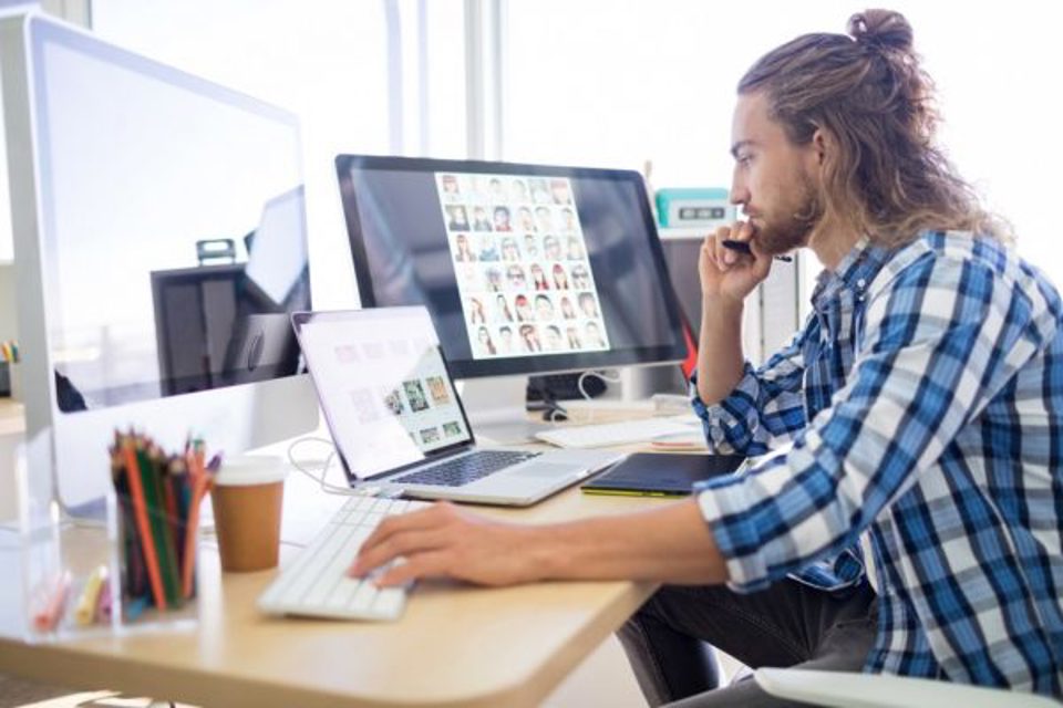 Man sitting at computers thinking