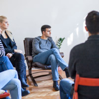 NDIS study area image - A group of people sitting in a circle and listening to one another talk