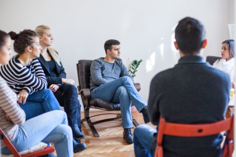 NDIS study area image - A group of people sitting in a circle and listening to one another talk