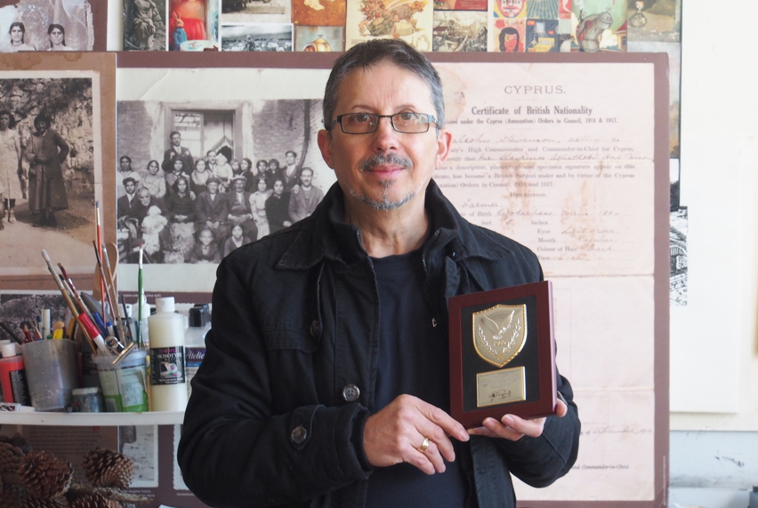 Con standing with his award