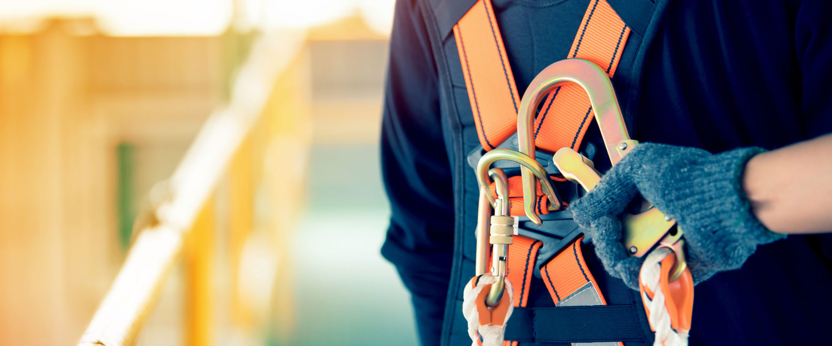 Someone connecting a cable rope to a person with a harness on