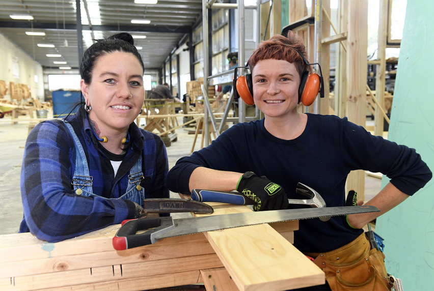 Two female carpentary students in Melbourne Polytechnic training warehouse