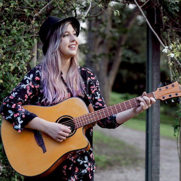 Portrait of Katelyn Sullivan holding guitar