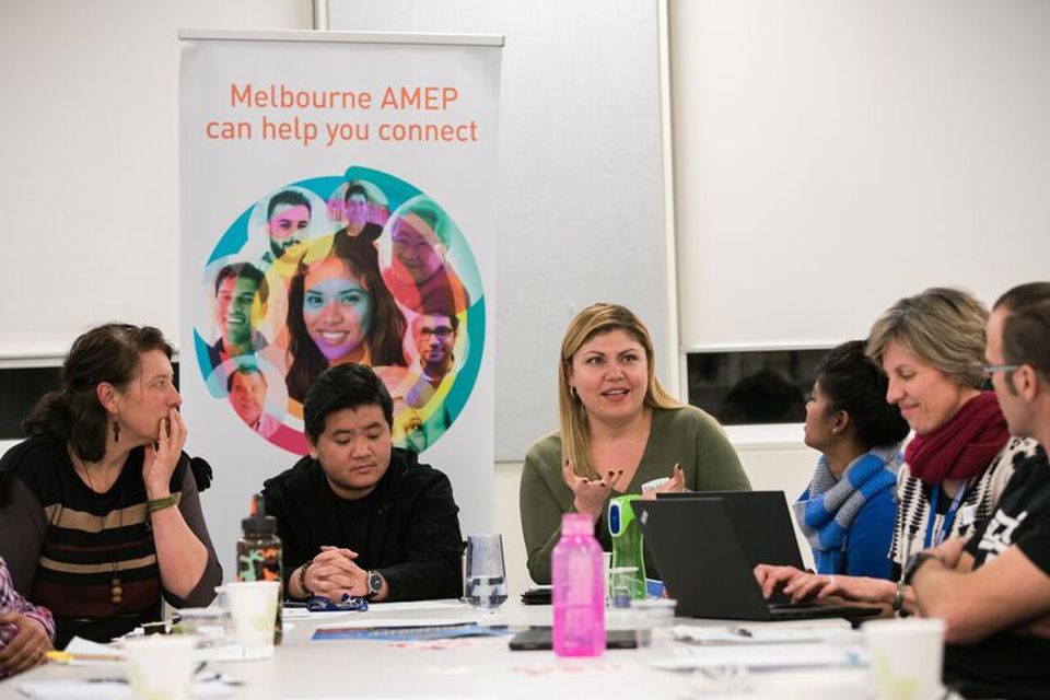 EAL, Adult Migrant English Program students sitting around table talking