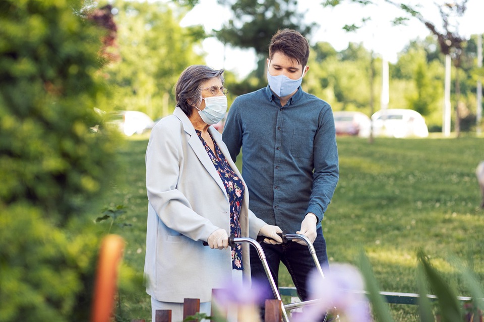 Elderly woman using walker