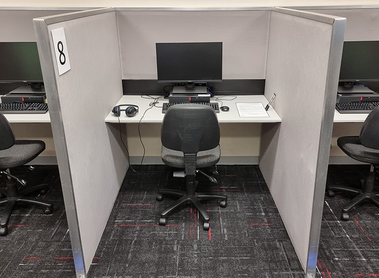 Pearson test centre room 313 cubicle with chair and computer.