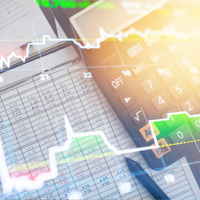 Accounting notebook and calculator with graph overlay