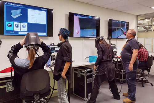 Female trade student practising on the virtual welders