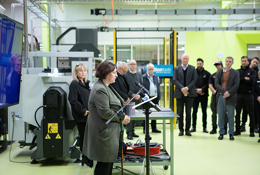 Frances Coppolillo, Chief Executive of Melbourne Polytechnic, speaking at the launch of the Advanced Centre of Excellence at Heidelberg with a crowd of people in the background