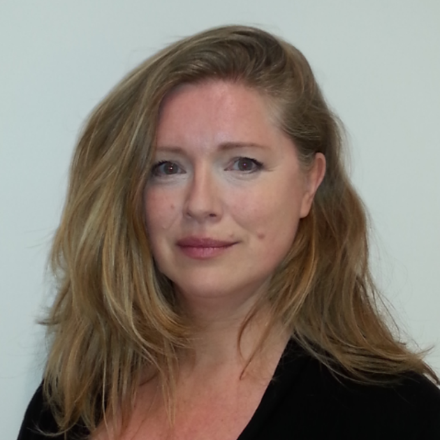 Portrait of Rhona O'loughlin with shoulder-length blonde hair, slightly parted in the middle, wearing a black top. She has a gentle smile and is looking directly at the camera.