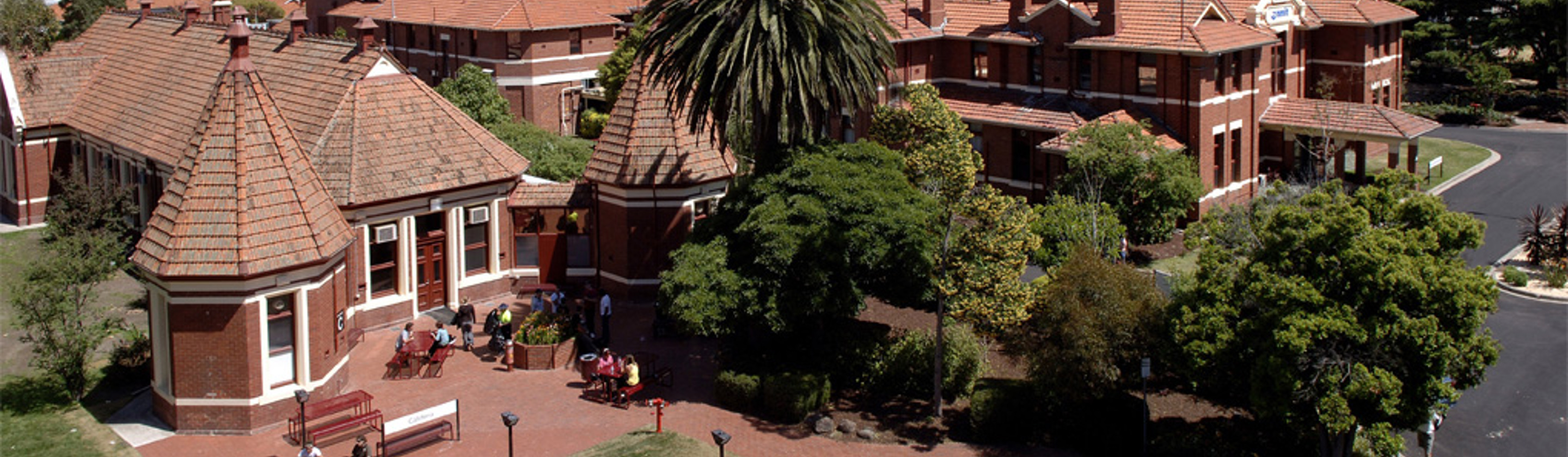 High angle image of Melbourne Polytechnic, Fairfield Campus with Melbourne cityscape in the distance