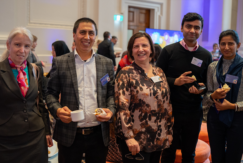 Five attendees, including Melbourne Polytechnic CEO, Frances Coppolillo, smile at the camera at the AMEP 75-year anniversary event